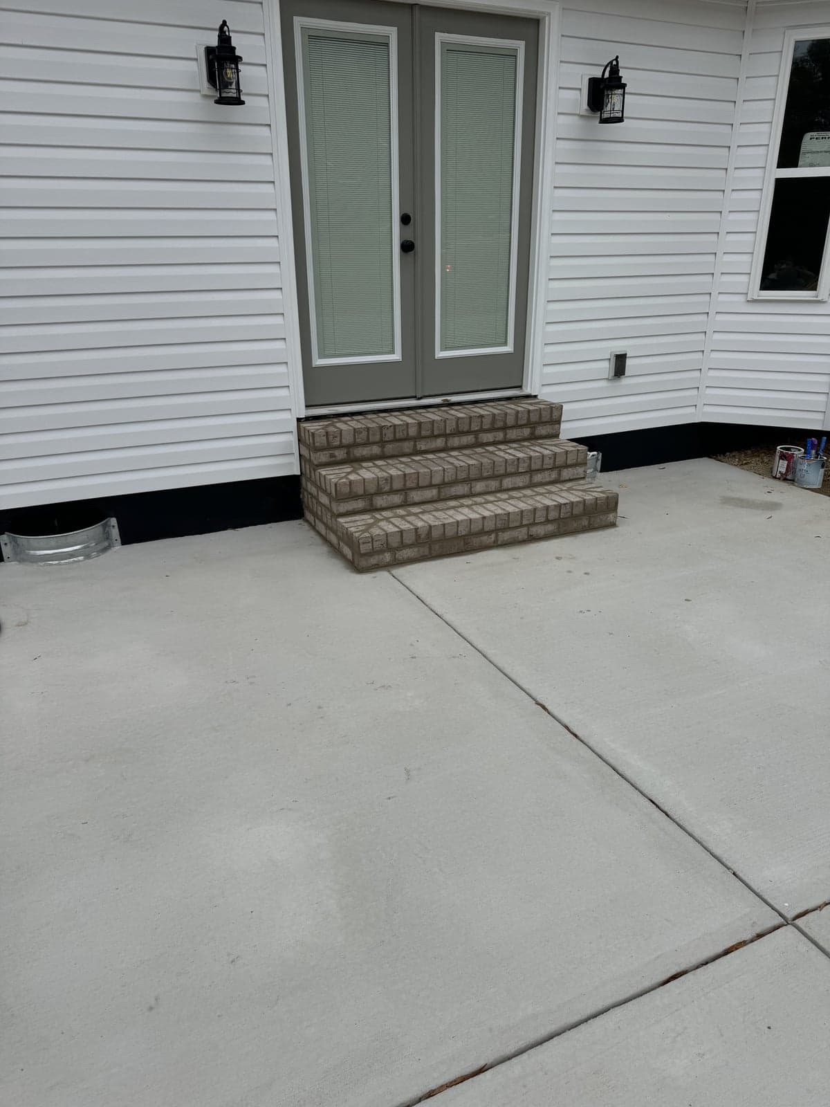 Brick step at a concrete patio entrance