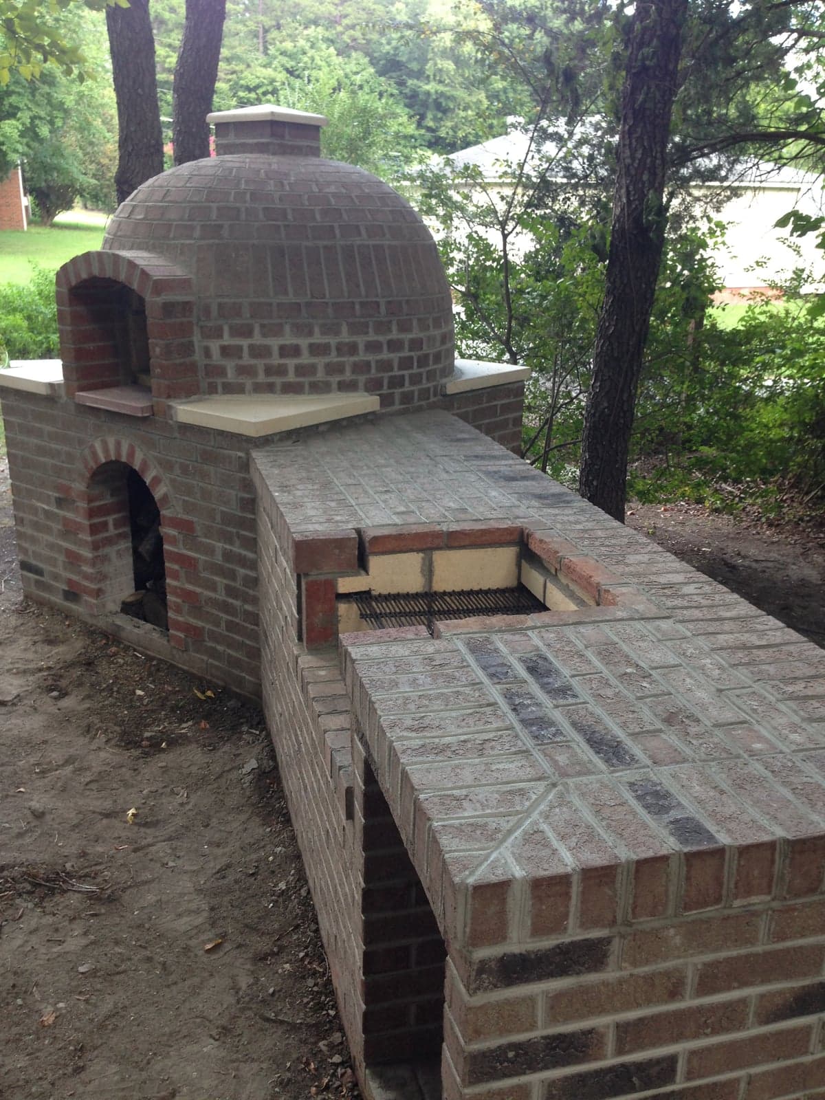 Custom brick pizza oven with barrel-shaped chamber