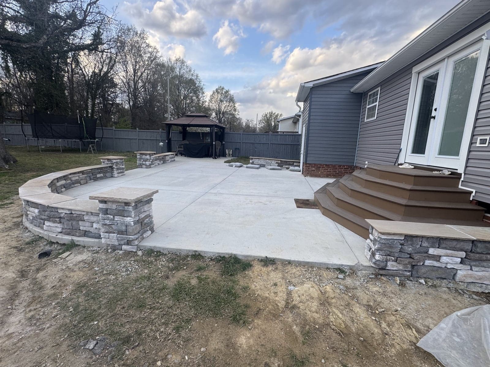 Stone seat wall with stamped concrete patio